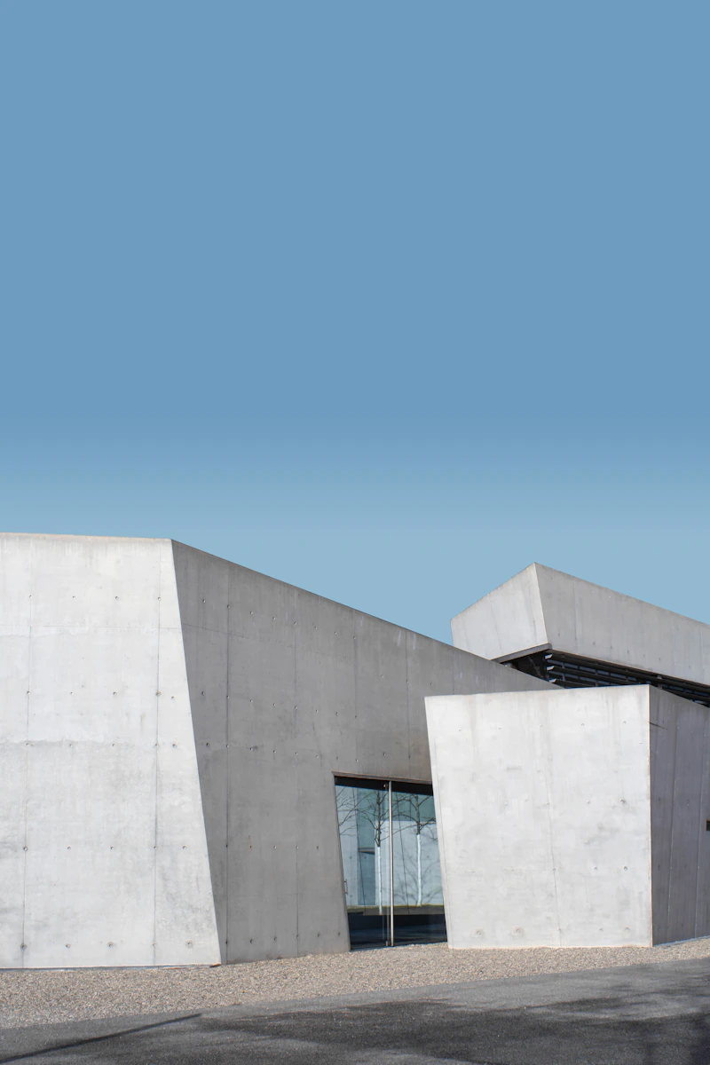 Sculptural concrete architecture under a blue sky